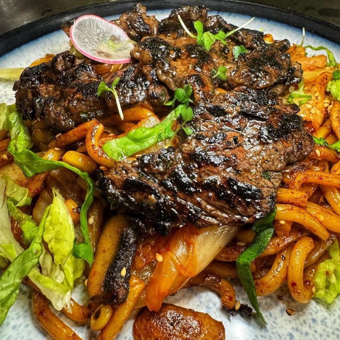 grilled beef over stir-fried noodles with vegetables served at Who’s 
Café 